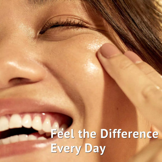 Woman with naturally glowing skin applying moisturizer during her daily skincare routine for healthy and hydrated skin.